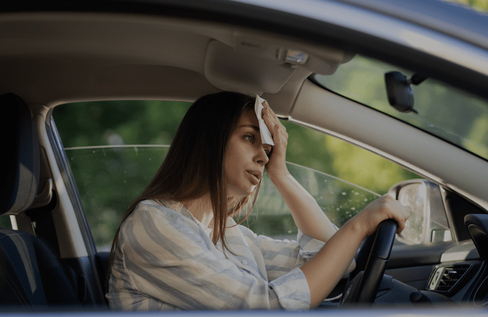 Female driver in hot car
